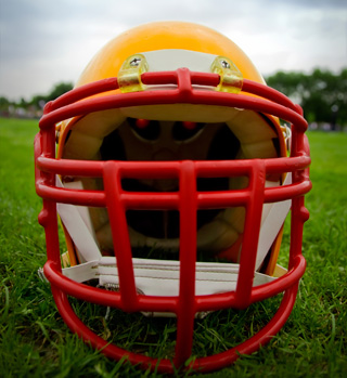 football helmet with red facemask on playing field
