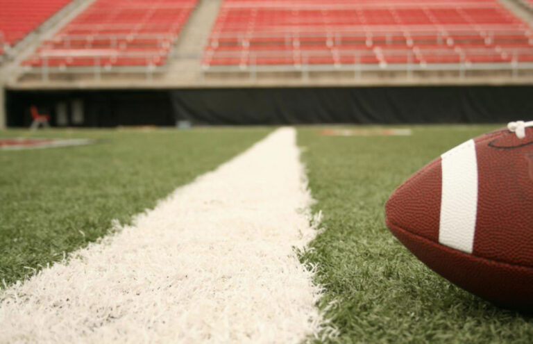 football by yard line on stadium field